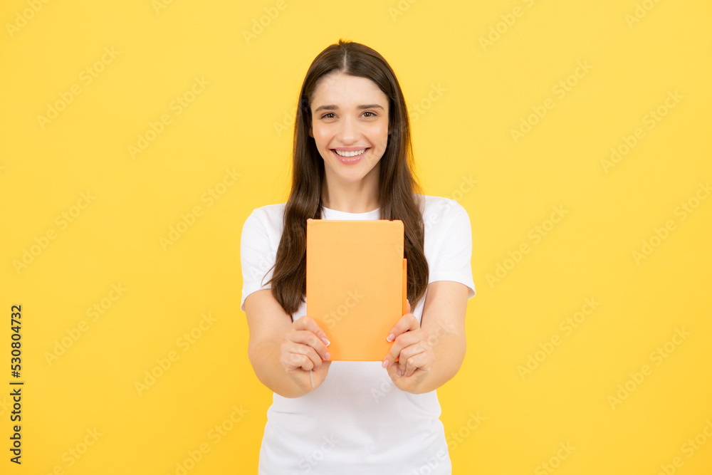 Charming student isolated on yellow color background. Woman high school student hold notebooks. Education in high school university college concept. Charming student isolated on yellow color background. Woman high school student hold notebooks. Education in high school university college concept.