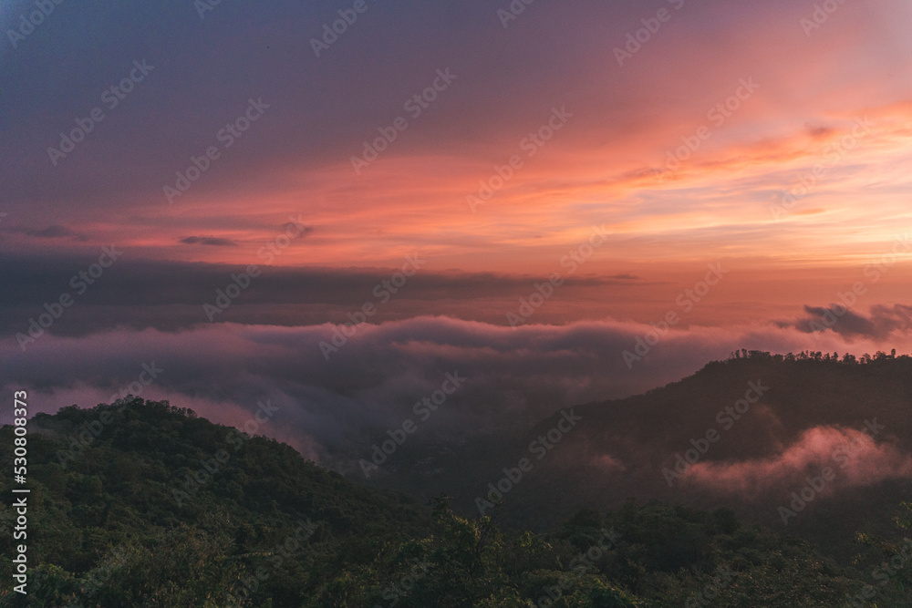 sunset in the mountains covered with fog 