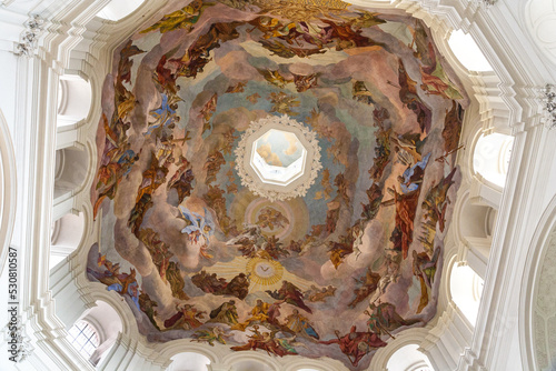 Beautiful close-up view of the large dome fresco in the cupola of the western octagon of the famous Neumünster Collegiate church in Würzburg, Germany. The dome painting depicts the heaven of saints.