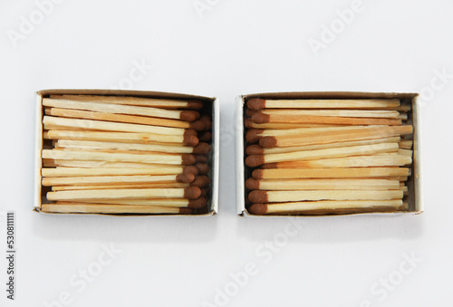 yellow wooden matches with a sulfur head in a cardboard box on a white background
