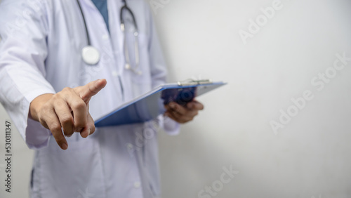 Doctor pressing button on virtual screen on background copy space for text.