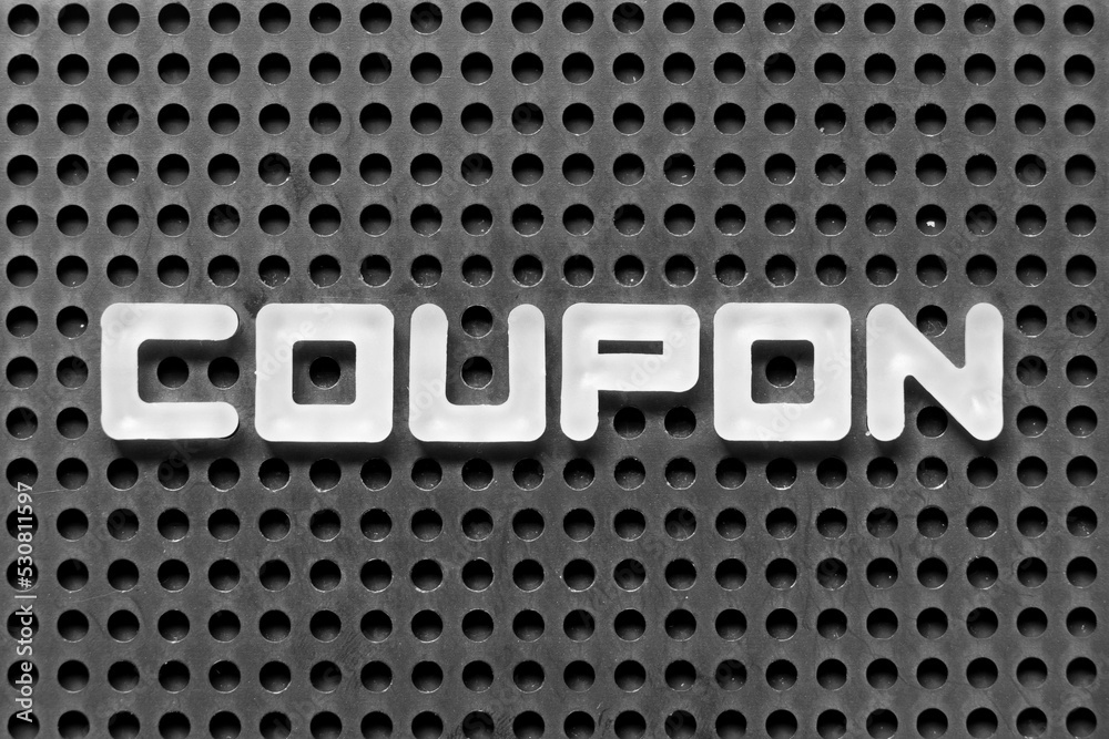 White alphabet letter in word coupon on black pegboard background White alphabet letter in word coupon on black pegboard background