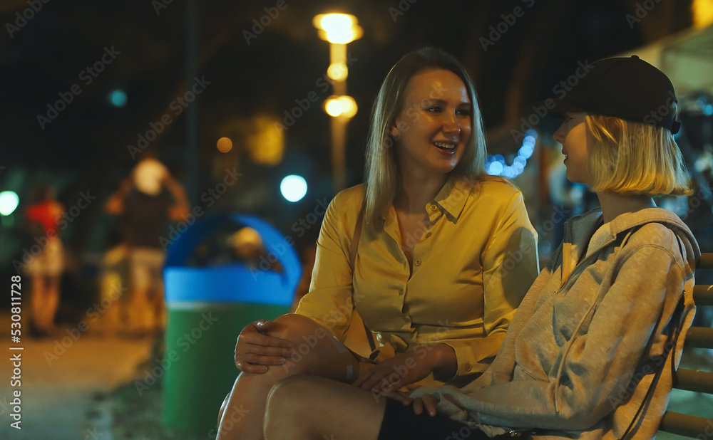 Mom and her daughter are sitting and talking. Mom and her daughter are sitting and talking.