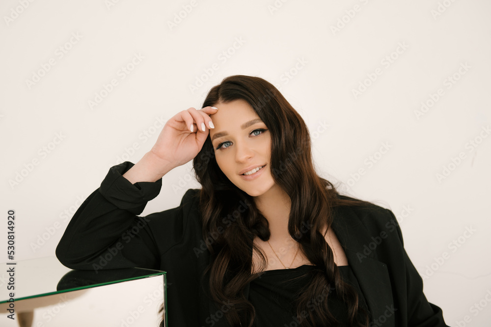 Beautiful pregnant girl with curls in a black dress on a white background, the concept of a happy pregnancy and family Beautiful pregnant girl with curls in a black dress on a white background, the concept of a happy pregnancy and family