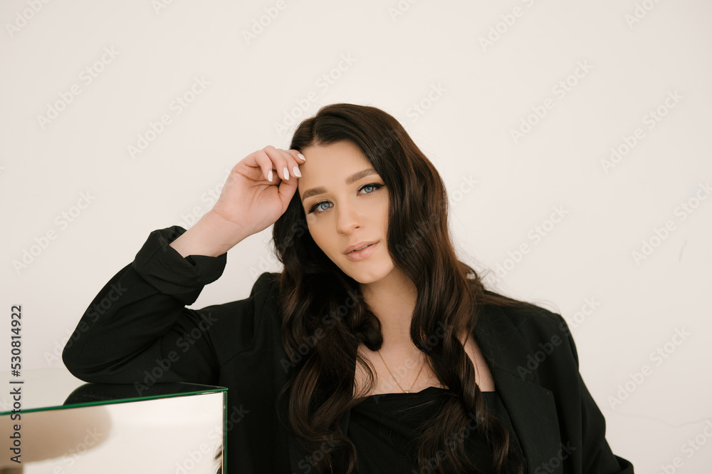 Beautiful pregnant girl with curls in a black dress on a white background, the concept of a happy pregnancy and family Beautiful pregnant girl with curls in a black dress on a white background, the concept of a happy pregnancy and family