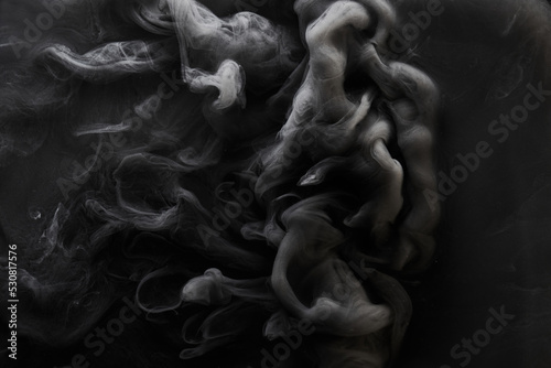 Black gray smoke abstract background, acrylic paint underwater explosion, swirling ink