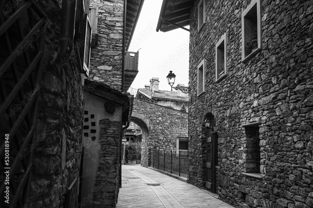 Black and white Photo of a Road without People with Rock Dwellings in Morgex in Aosta Valley, Italy