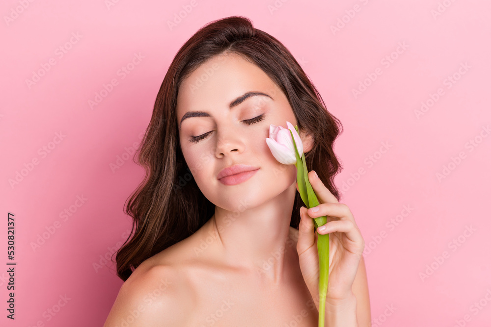 Photo of charming shiny young nude lady wear nothing tulip blossom touching cheek isolated pink color background Photo of charming shiny young nude lady wear nothing tulip blossom touching cheek isolated pink color background