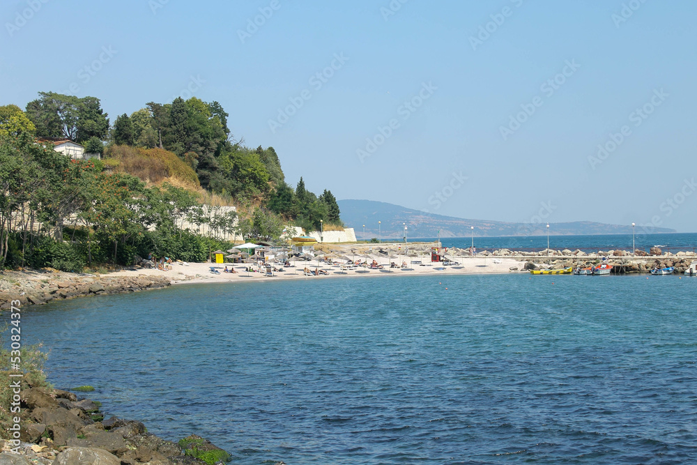 the black sea in Bulgaria in summer. View from afar of the pier, the city and the mountains the black sea in Bulgaria in summer. View from afar of the pier, the city and the mountains