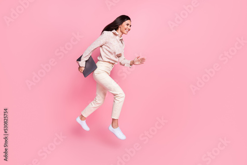 Full body photo of cheerful agent lady jump hurry for eshop discounts isolated on pastel color background