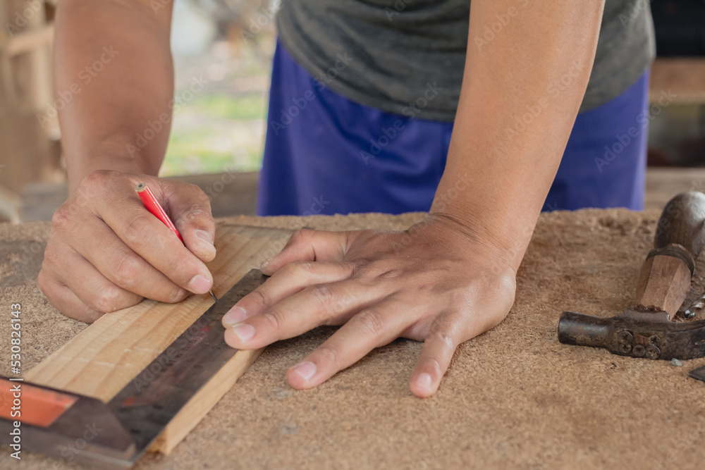 craftsman using the pencil marking make on the wooden product working at carpentry workshop furniture project craftsman using the pencil marking make on the wooden product working at carpentry workshop furniture project