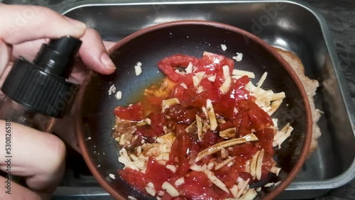 spraying sauce on salad 