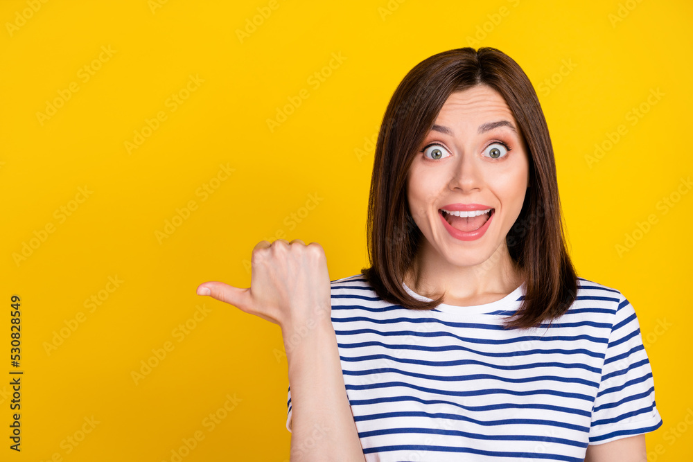 Closeup photo of young gorgeous funny woman shocked surprised directing empty space crazy news isolated on yellow color background Closeup photo of young gorgeous funny woman shocked surprised directing empty space crazy news isolated on yellow color background