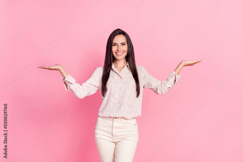 Photo of positive lady promoter hold hands weighing two adverts isolated on pastel color background