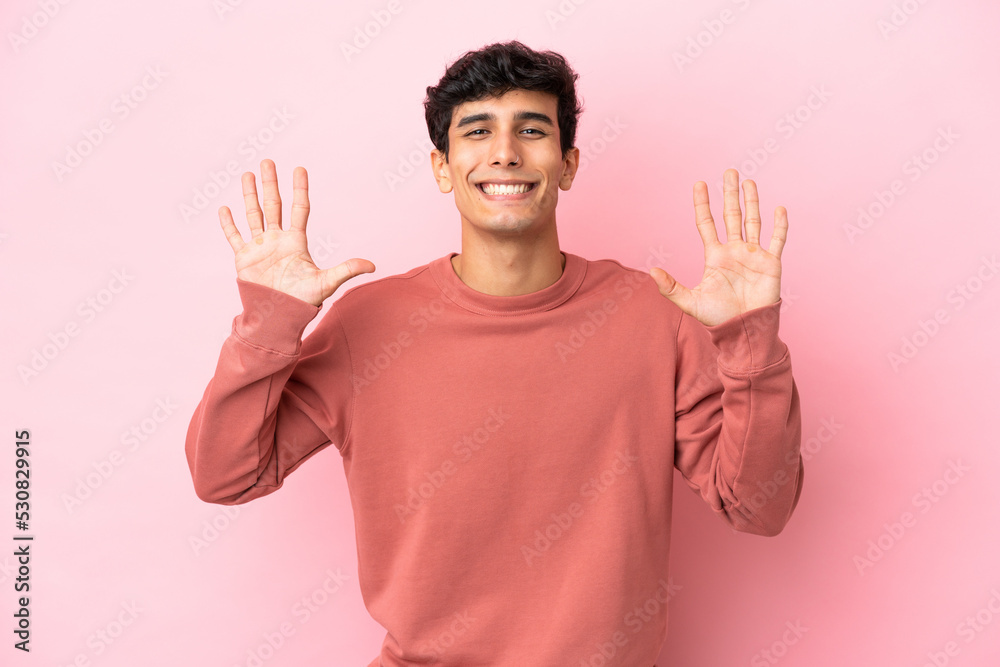 Young Argentinian man isolated on pink background counting ten with fingers Young Argentinian man isolated on pink background counting ten with fingers