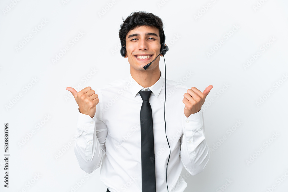 Telemarketer man working with a headset isolated on white background with thumbs up gesture and smiling Telemarketer man working with a headset isolated on white background with thumbs up gesture and smiling