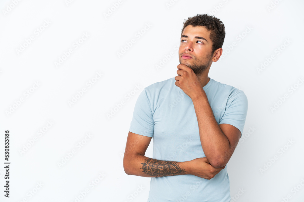 Young handsome Brazilian man isolated on white background thinking an idea while looking up Young handsome Brazilian man isolated on white background thinking an idea while looking up
