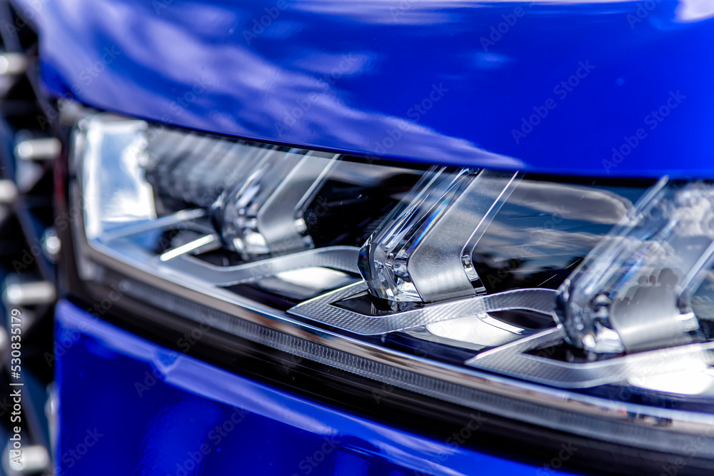 cheeky blue car headlight shot close up