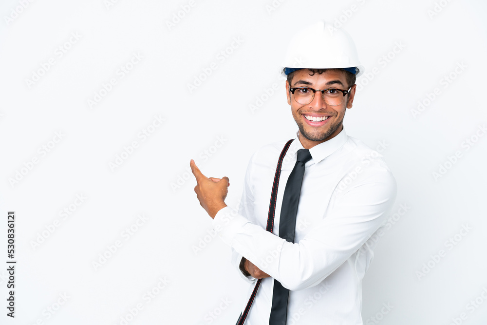 Architect brazilian man with helmet and holding blueprints pointing back Architect brazilian man with helmet and holding blueprints pointing back