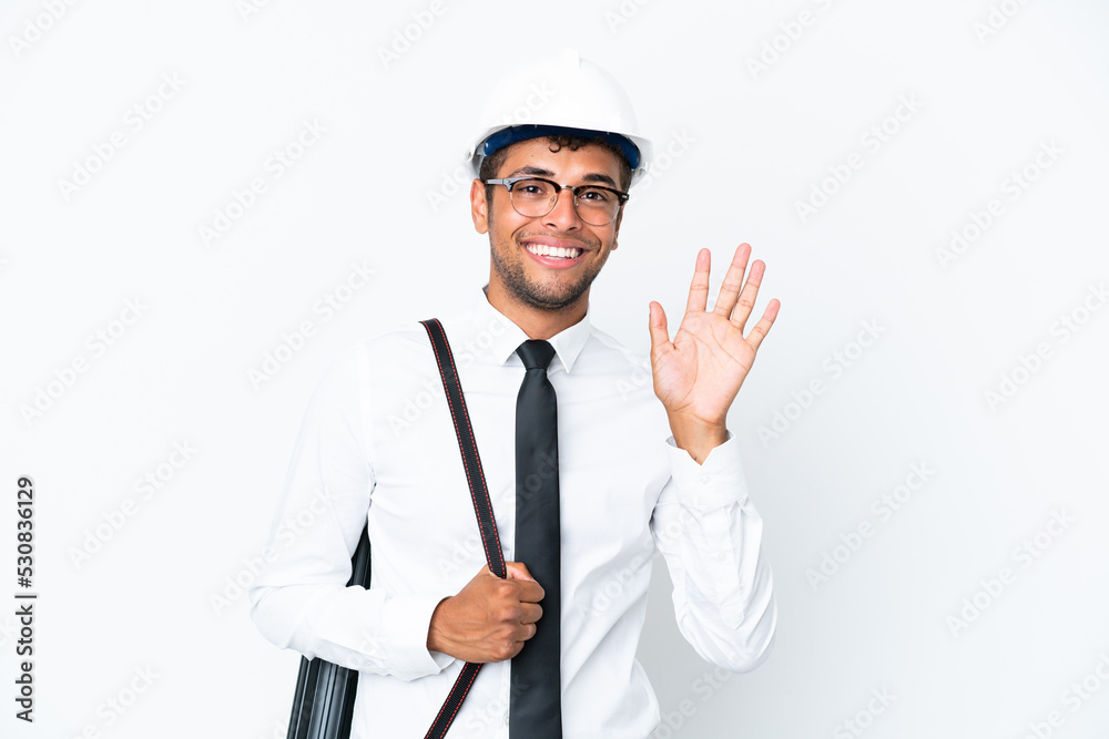 Architect brazilian man with helmet and holding blueprints saluting with hand with happy expression Architect brazilian man with helmet and holding blueprints saluting with hand with happy expression