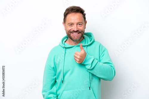 Middle age caucasian man isolated on white background giving a thumbs up gesture © luismolinero