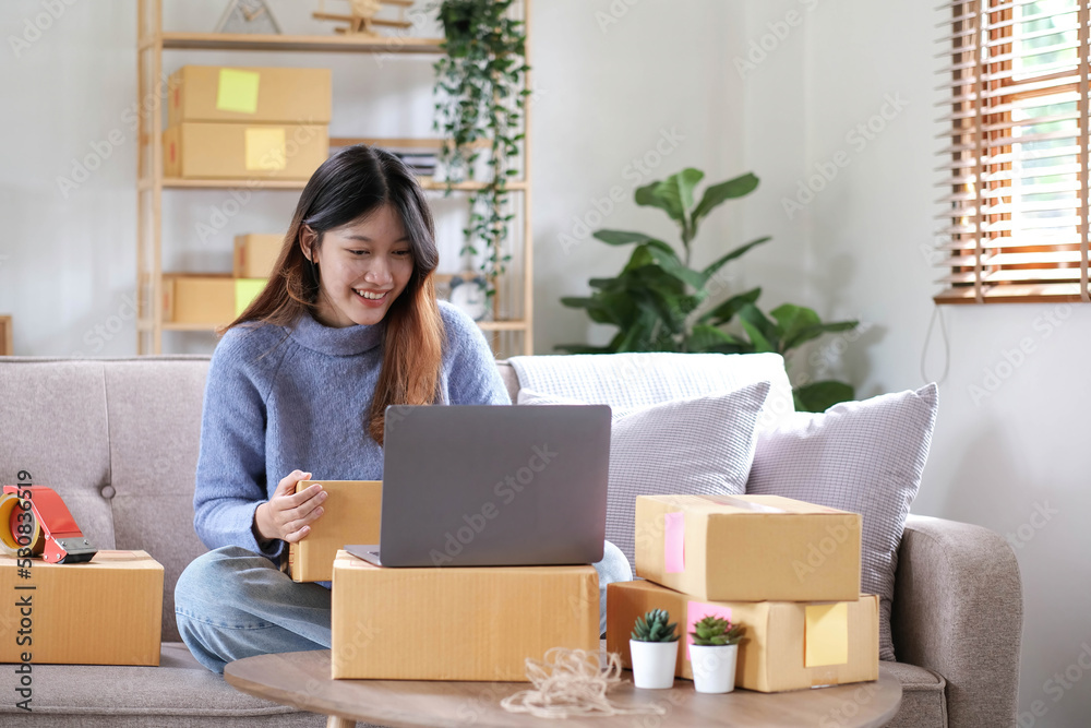 Starting Small business entrepreneur freelance, Portrait young woman working at home office, BOX, smartphone, laptop, online, marketing, packaging, delivery, b2b, SME, e-commerce concept