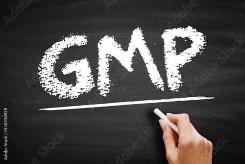 GMP Good Manufacturing Practice - system for ensuring that products are consistently produced and controlled according to quality standards, acronym text on blackboard