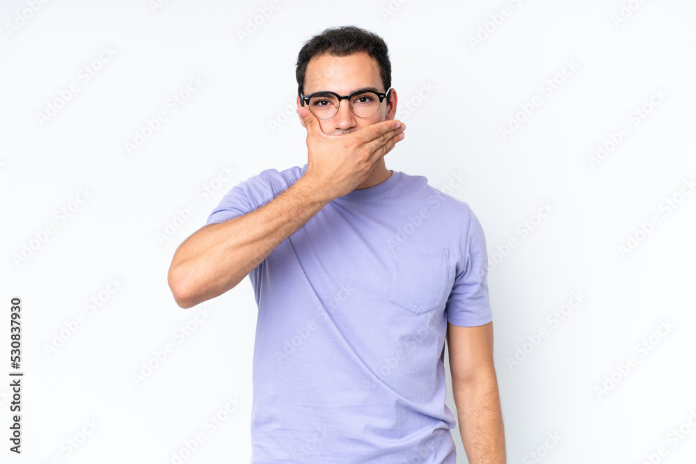 Young caucasian man isolated on white background covering mouth with hand Young caucasian man isolated on white background covering mouth with hand