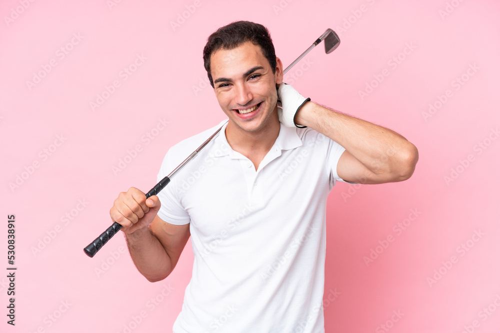 Young golfer player man isolated on pink background laughing Young golfer player man isolated on pink background laughing