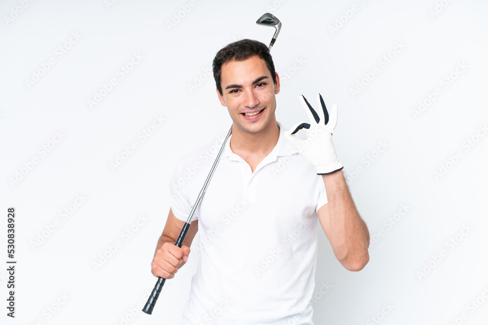 Young caucasian man isolated on white background playing golf making OK sign Young caucasian man isolated on white background playing golf making OK sign