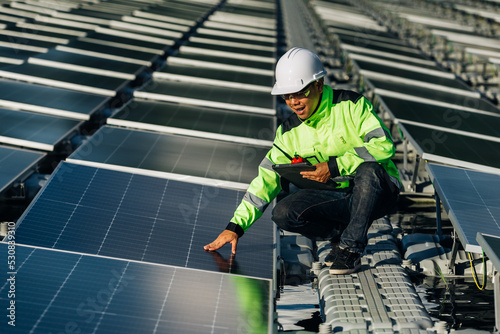 The portrait of a asian young engineer checks photovoltaic solar panels. Concept. renewable energy technology electricity service, green power.