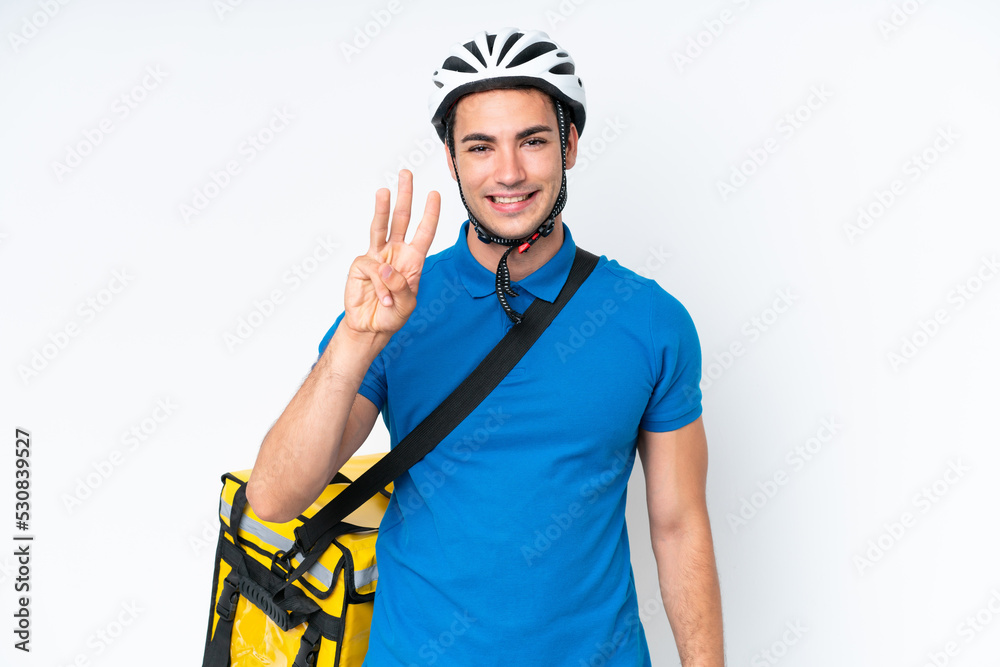 Young caucasian man with thermal backpack isolated on white background happy and counting three with fingers Young caucasian man with thermal backpack isolated on white background happy and counting three with fingers