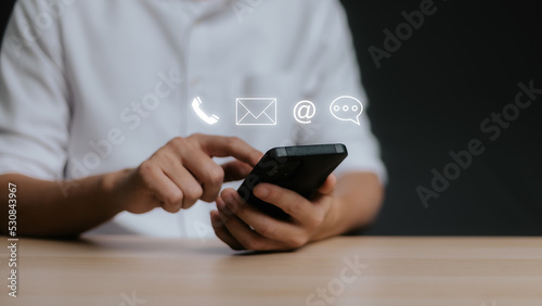 Customer support hotline Contact us people connection. Businessman using Smart Phone with the
