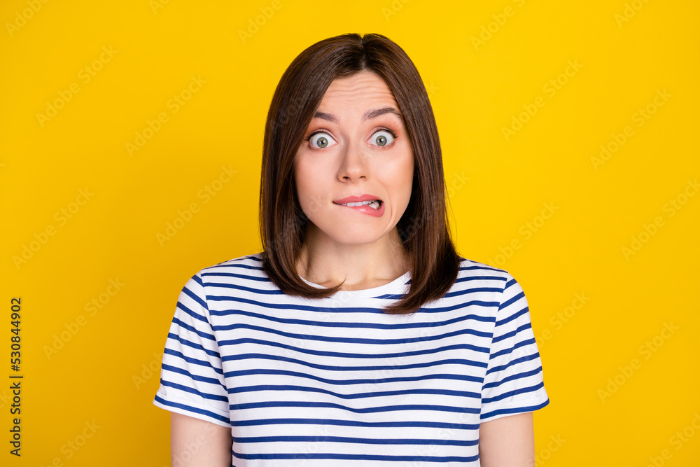 Closeup photo of young funny nervous woman bite lips sorry businesswoman forgot pay salary workers isolated on yellow color background Closeup photo of young funny nervous woman bite lips sorry businesswoman forgot pay salary workers isolated on yellow color background