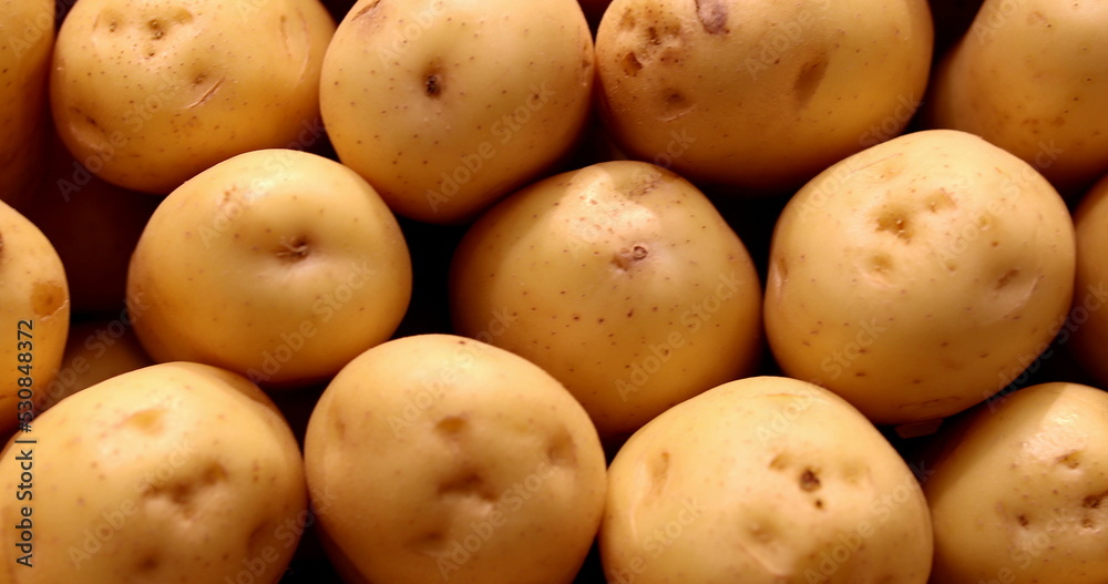 Pile of potatoes gathered together at grocery on display Pile of potatoes gathered together at grocery on display