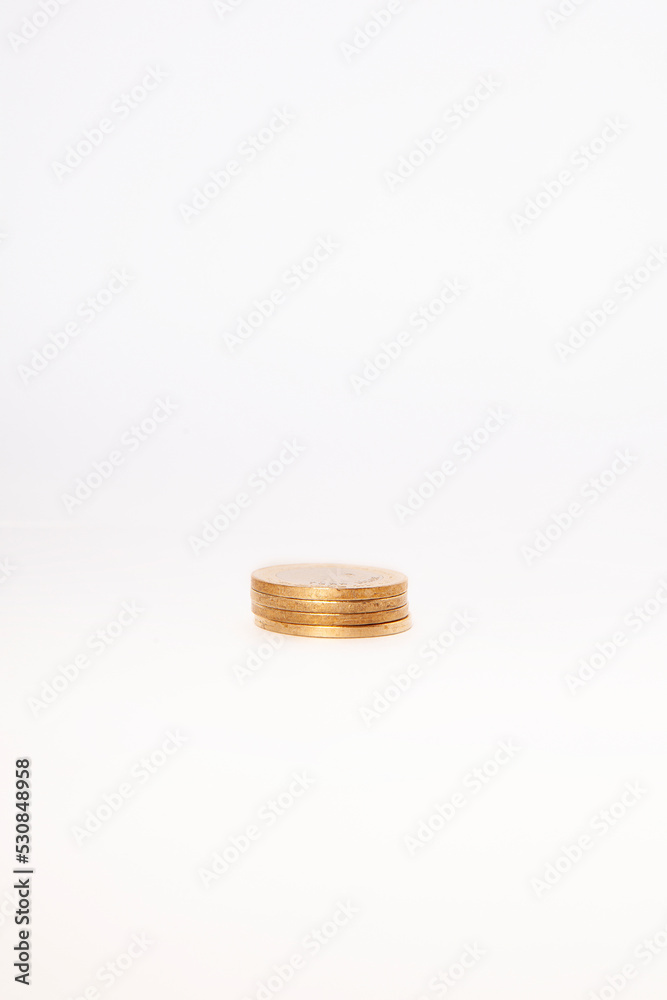 Close-up of coins stack on white background. Close-up of coins stack on white background.