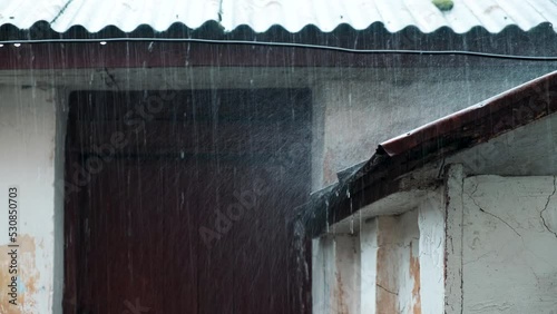 Raindrops fall on the roof of an old building. Autumn rainfall