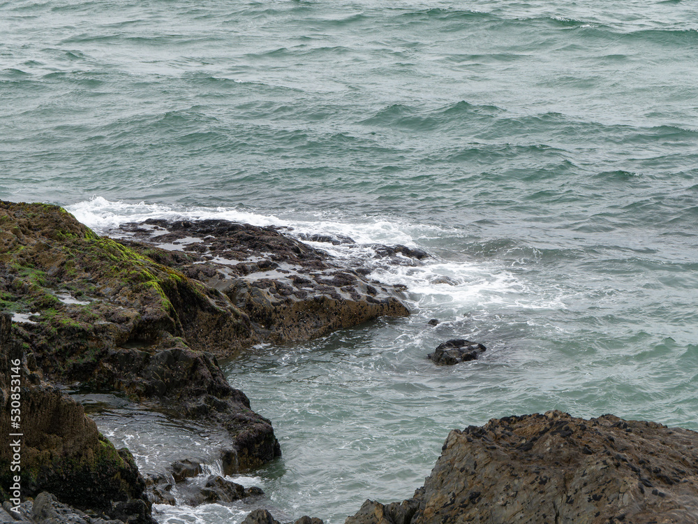 Wild rock, rock formation beside of water. Ocean waves & Coastal Cliffs