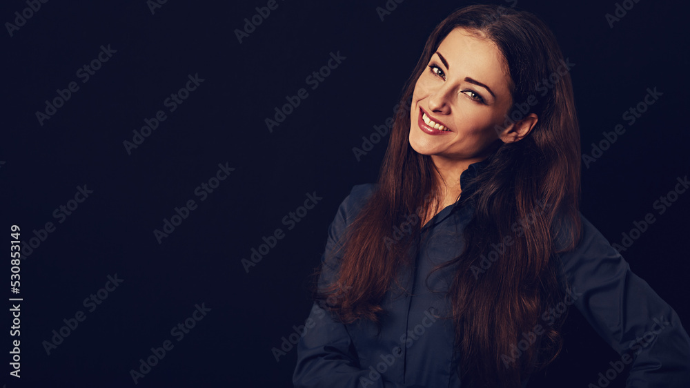 Beautiful thinking toothy smiling business woman with folded arms in blue shirt on black background with empty copy space for text. Closeup Beautiful thinking toothy smiling business woman with folded arms in blue shirt on black background with empty copy space for text. Closeup