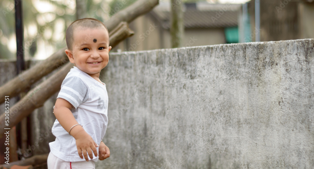 Cute smart naughty baby making a funny and looking at camera. Happy baby background. Cute smart naughty baby making a funny and looking at camera. Happy baby background.