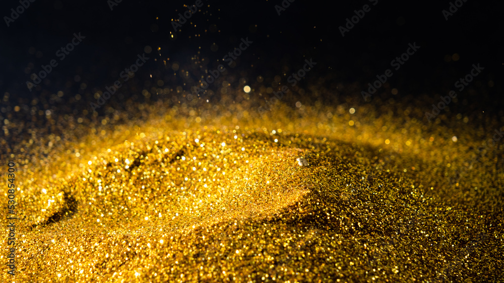 Sprinkle glitter gold dust sand in the dark textured abstract background elegant for Merry christmas and Happy new year Sprinkle glitter gold dust sand in the dark textured abstract background elegant for Merry christmas and Happy new year
