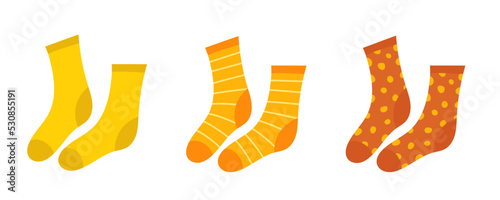 Socks. A set of orange and yellow socks. Warm striped and polka dot socks. Vector clipart isolated on white background.
