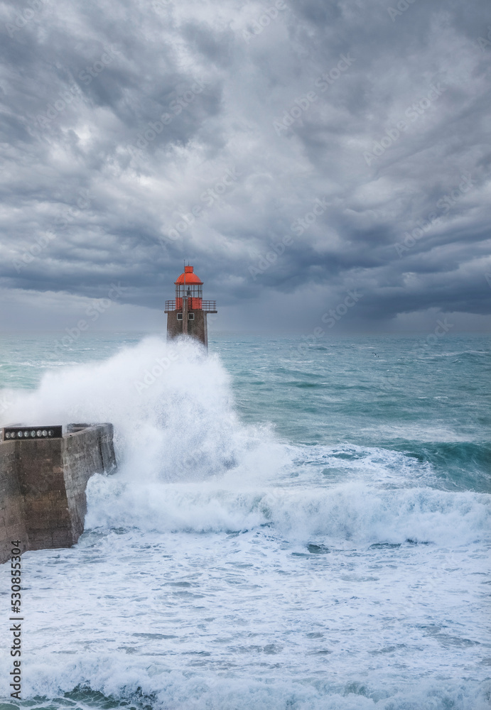 Fécamp's red lighthouse hit by a crashing wave on a storm day - sea lighthouse with dramatic sky, Normandy