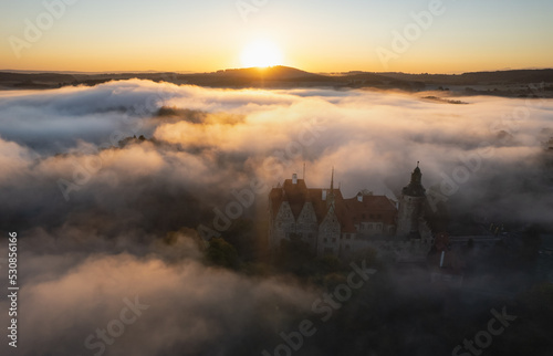 Czocha Castle in Lower Silesia on a foggy autumn morning,Poland photo