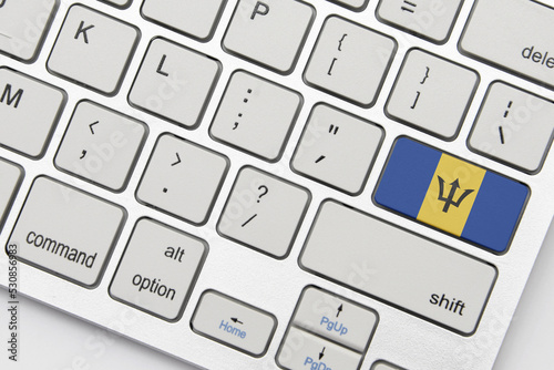 national flag of barbados on the keyboard on a grey background .3d illustration