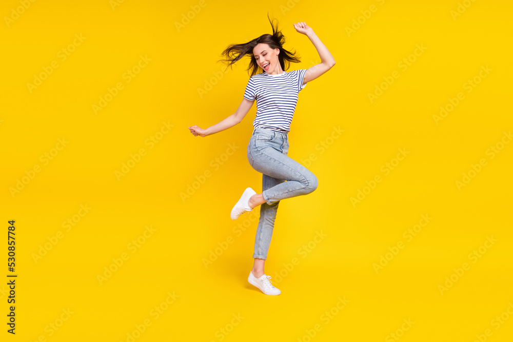 Photo of pretty satisfied lady sexy shape raise arm palm leg rejoice sale discount empty space isolated on yellow color background