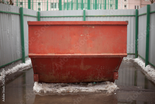 Garbage container. Steel waste tank in city. Large garbage can in yard. © Олег Копьёв