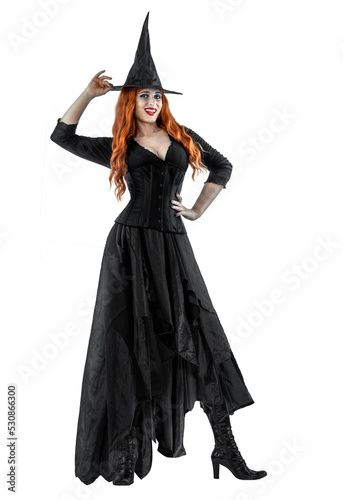 Witch on Halloween. Female wizard fairy character for All Saints' Day. Fantasy gothic red-haired Vampire girl in black dress. Enchantress dressed in carnival costume