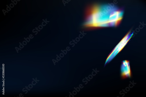 Rainbow highlights on a black background.Glare or reflection from water and glass.Glittering particles for social media backgrounds, product presentations, photo shots.