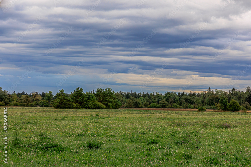 Dark thunderclouds over the meadows of the village Siebenbrunn near Augsburg at the edge of the forest Dark thunderclouds over the meadows of the village Siebenbrunn near Augsburg at the edge of the forest